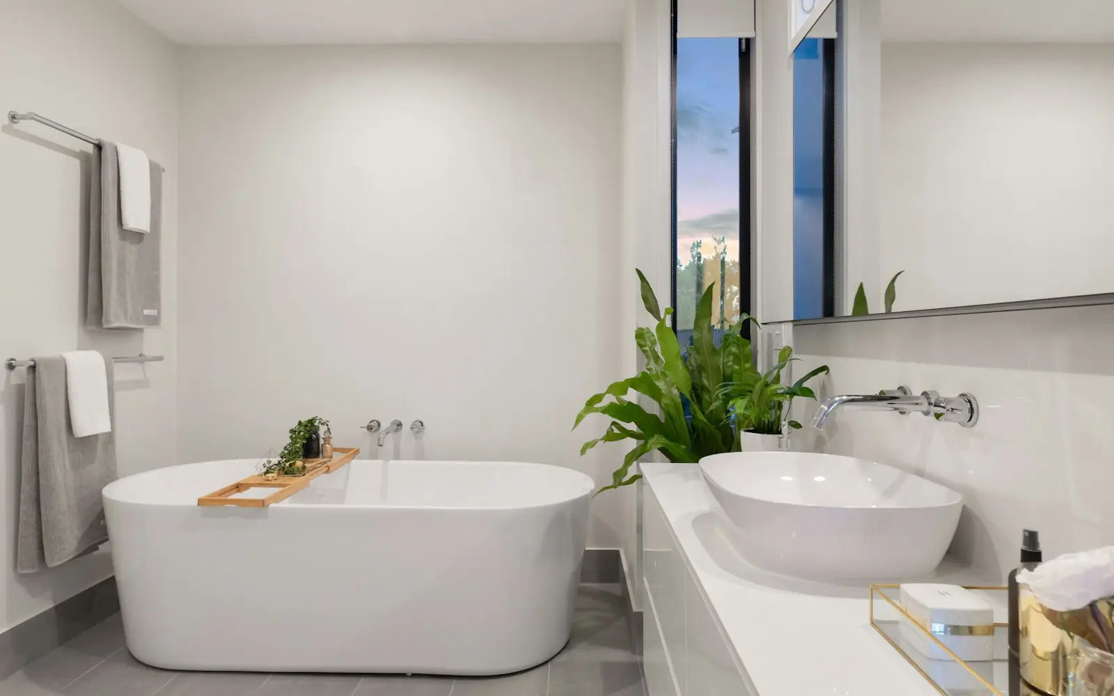 Clean white freestanding bathtub in a bright modern bathroom